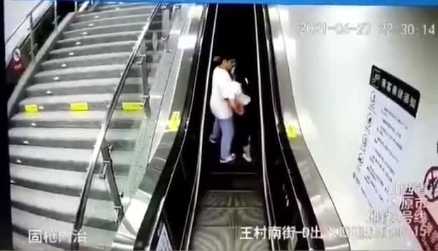 Couple kisses on escalator and finds out