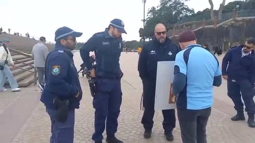 Police force Christian man to leave the Sydney Opera House area for holding a Jesus sign.  "This is Australia"