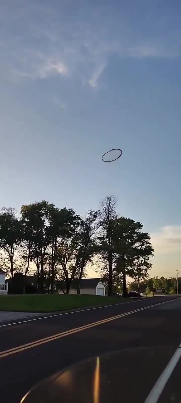 I don’t think we are in Kansas any more..   Kansas man films bizarre black ring in sky while riding motorcycle.  What do you think it is?