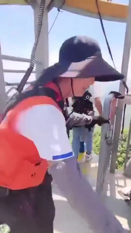 A tourist in China jumps at a bungee jumping location without being secured by a safety rope