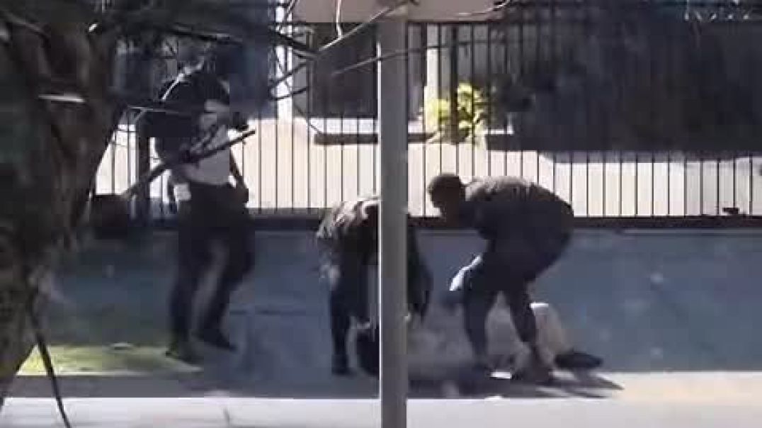 A group of Africans, including one armed with a handgun, run from the scene of a brawl in St Kilda, Melbourne, at 11am this morning where shots were fired and a man's head stomped on.  Police arr