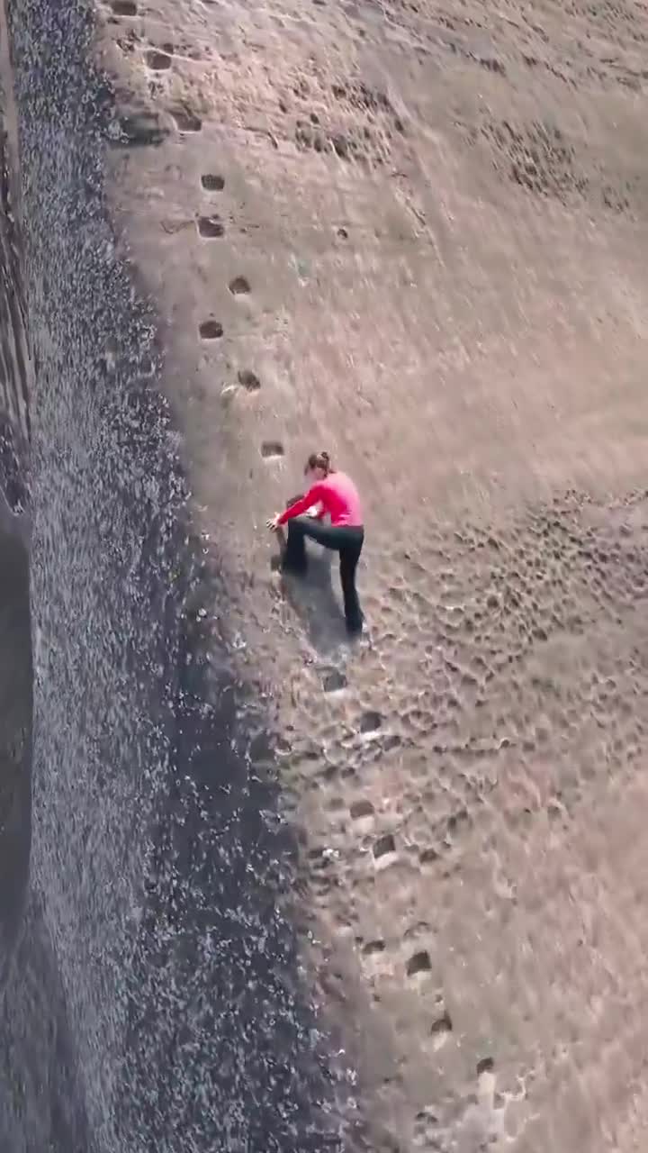 INSANE CLIMB IN CHINA TAKES FREE CLIMBING TO NEW CRAZY HEIGHTS  A woman scales a near-vertical Danxia cliff with nothing but carved footholds: no rope, no harness, no fear.  One wrong move a...