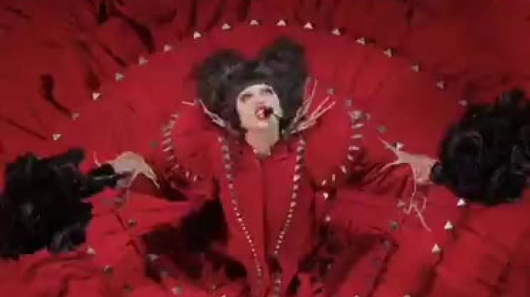 Lady Gaga appeared in blood-red attire during yesterday’s Blood Moon Lunar Eclipse, surrounded by priests dancing as caged women writhed beneath her.   The performance is being described by many viewe