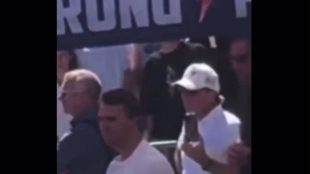 Who is the person behind Charlie Kirk and why is he making what appears to be a “signal” immediately preceding Charlie being shot. This is NOT a normal gesture any person would ever make.