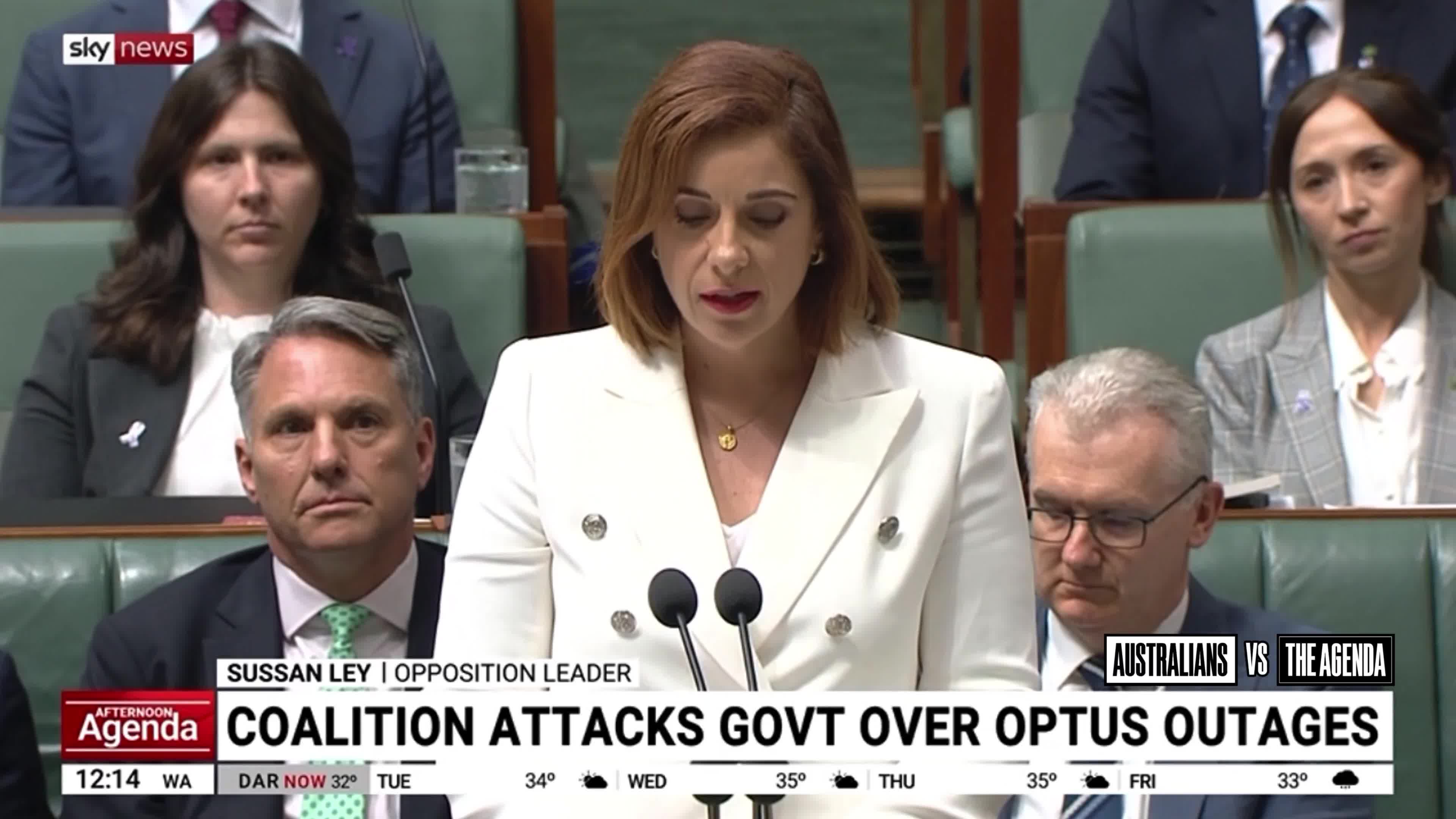 Communications Minister Anika Wells has defended flying to New York to promote the social media ban at the United Nations while Australians were dying during the Triple-Zero outage, blaming ...