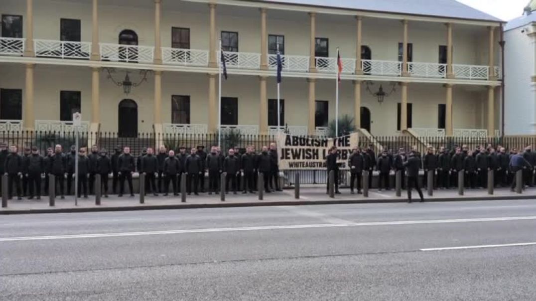 The National Socialist Network protesting outside NSW Parliament in Sydney with a banner saying "Abolish the Jewish lobby".