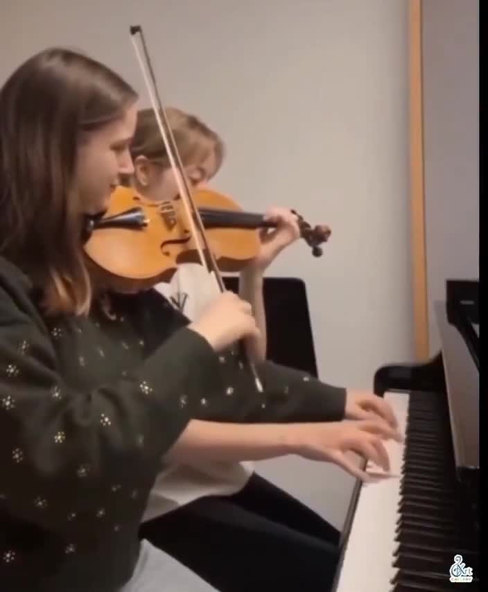 Each girl is playing both instruments at the same time
