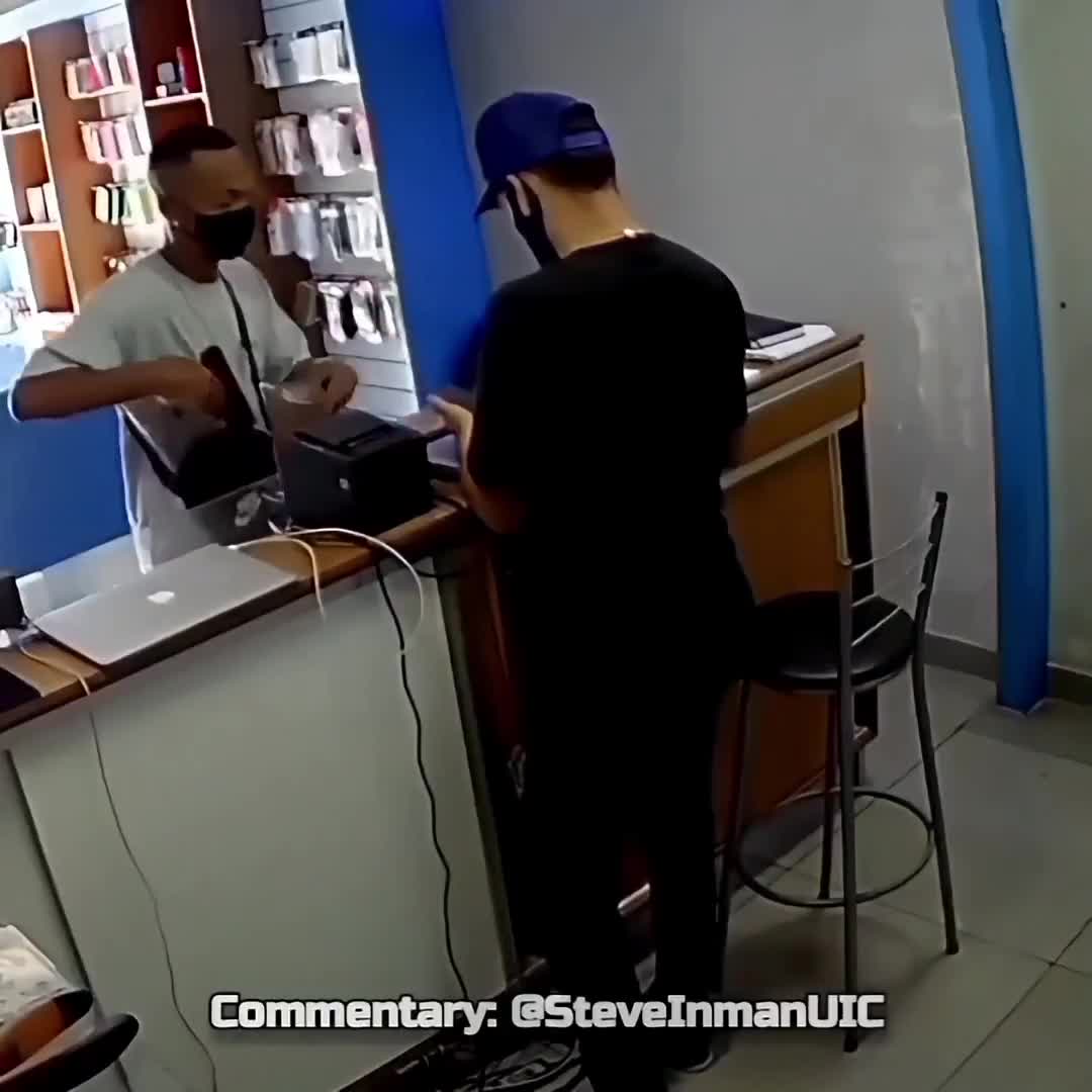 Robber gets help with checking out from the manager.