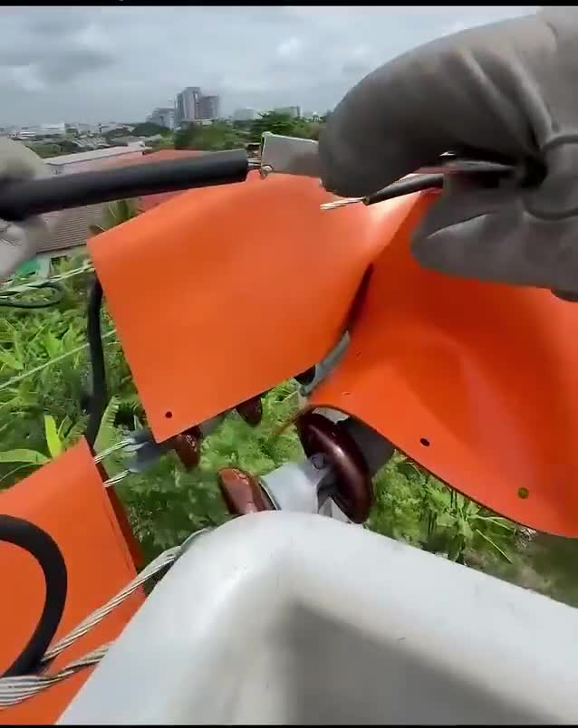 This is how linemen connect 22,000-volt power lines without ever turning the electricity off