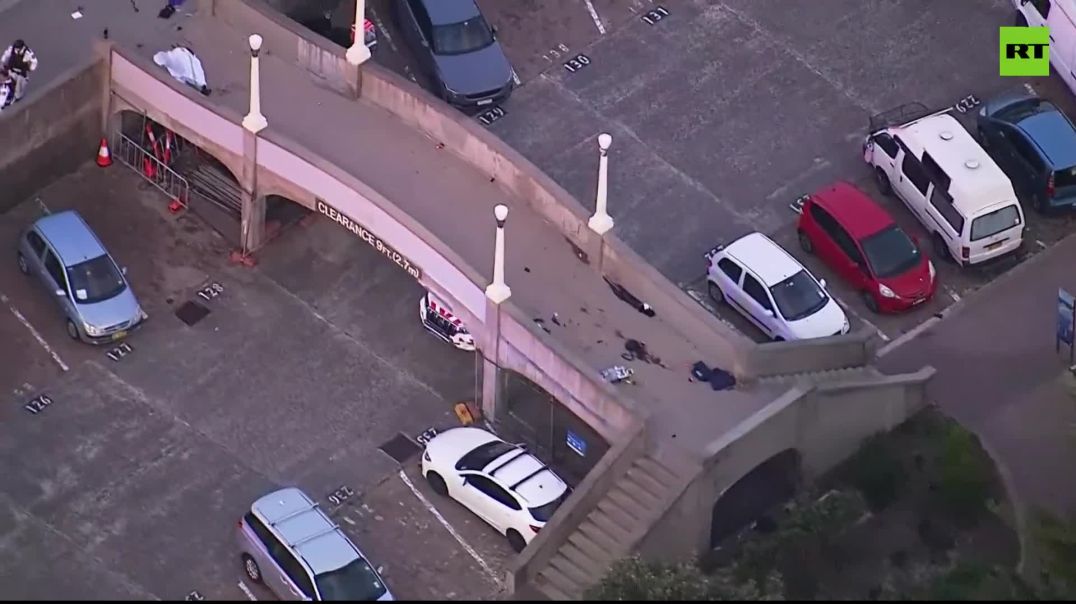 Chopper view of bridge where gunmen detained  Blood splattered on ground, white sheet covers BODY